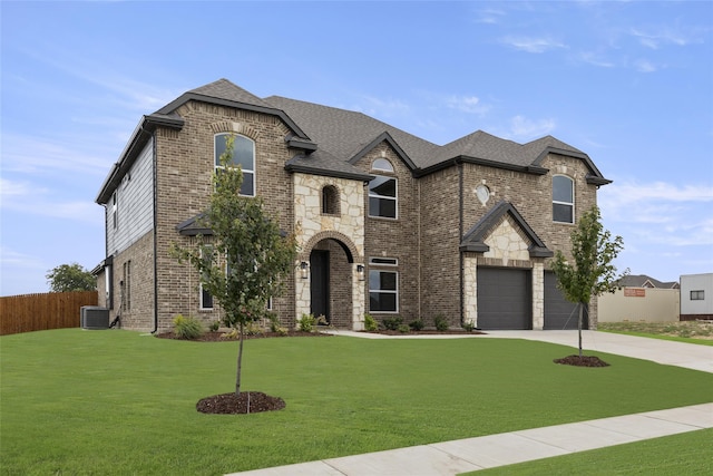 french country style house with a garage, central AC unit, and a front yard