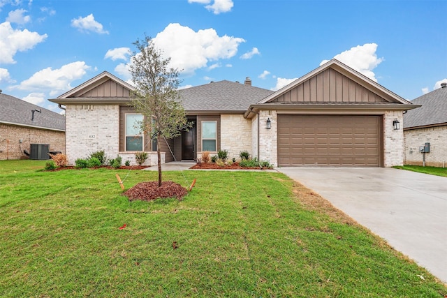 view of front of home with a garage, central AC unit, and a front lawn