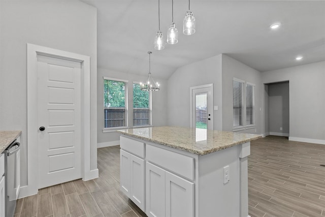 kitchen with light hardwood / wood-style flooring, white cabinetry, pendant lighting, and a center island