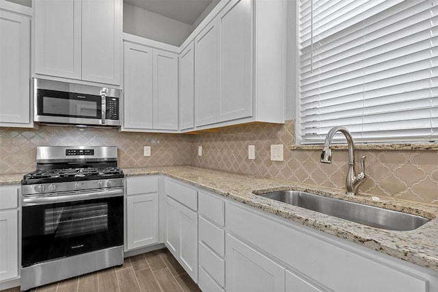 kitchen with white cabinets, sink, and stainless steel appliances