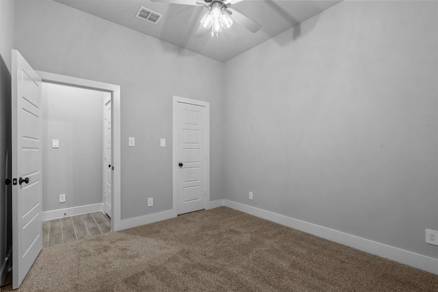 unfurnished bedroom featuring ceiling fan and light colored carpet