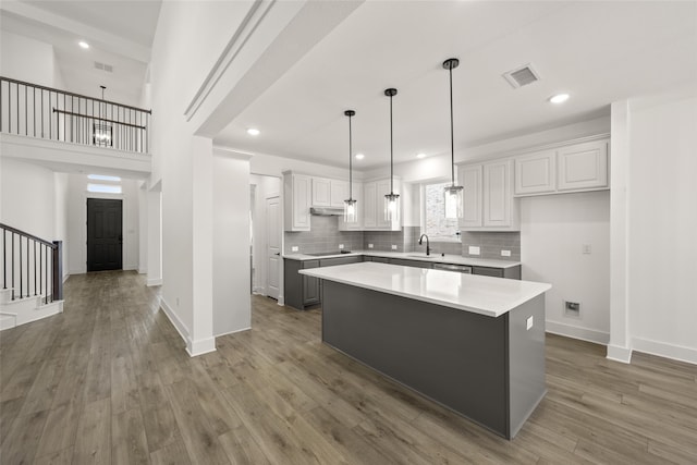 kitchen featuring white cabinetry, dark hardwood / wood-style flooring, and a center island