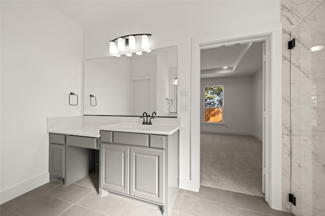 bathroom with tile patterned flooring, vanity, and walk in shower