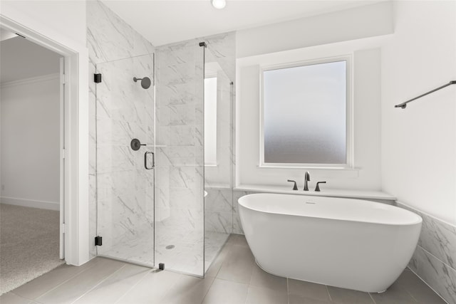 bathroom featuring tile patterned floors and separate shower and tub