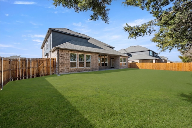 rear view of property with a lawn