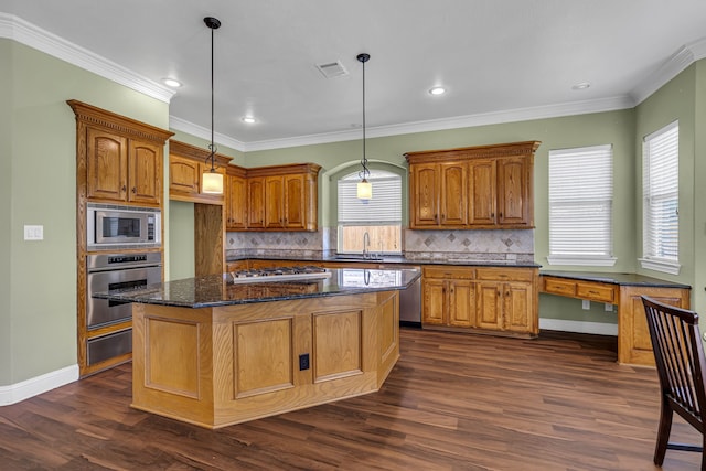 kitchen featuring stainless steel appliances, a kitchen island, backsplash, and dark hardwood / wood-style floors