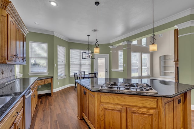 kitchen featuring decorative light fixtures, appliances with stainless steel finishes, dark hardwood / wood-style flooring, and a kitchen island