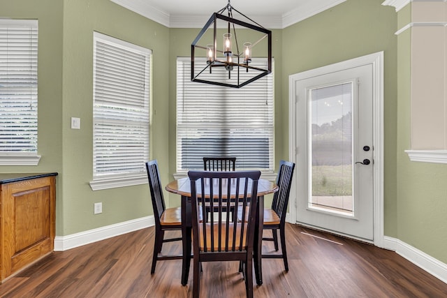 dining space with crown molding, an inviting chandelier, and dark hardwood / wood-style flooring