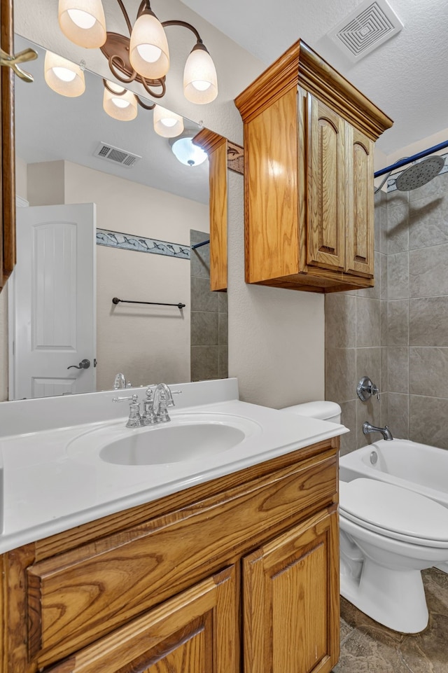 full bathroom with tiled shower / bath combo, vanity, toilet, and tile floors