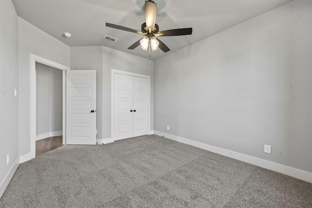 unfurnished bedroom with baseboards, visible vents, a ceiling fan, carpet flooring, and a closet