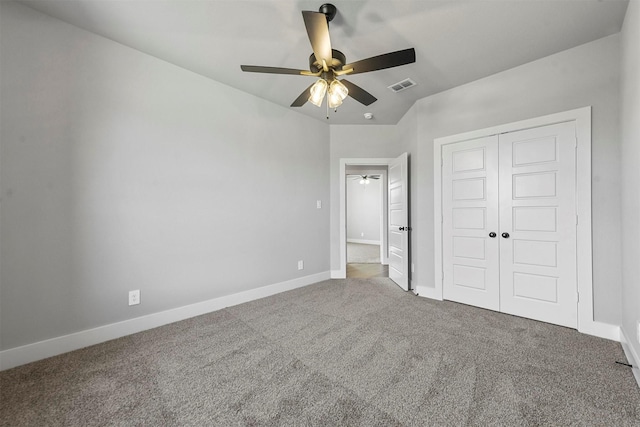 unfurnished bedroom with baseboards, a closet, visible vents, and carpet flooring