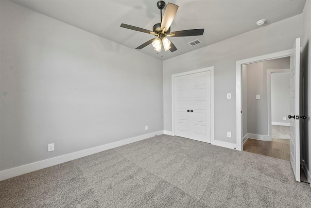 unfurnished bedroom featuring visible vents, baseboards, ceiling fan, carpet, and a closet