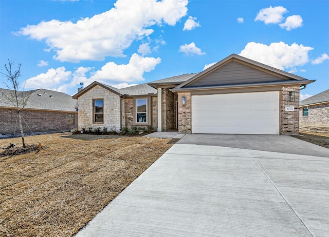 view of front of house with an attached garage, concrete driveway, and brick siding