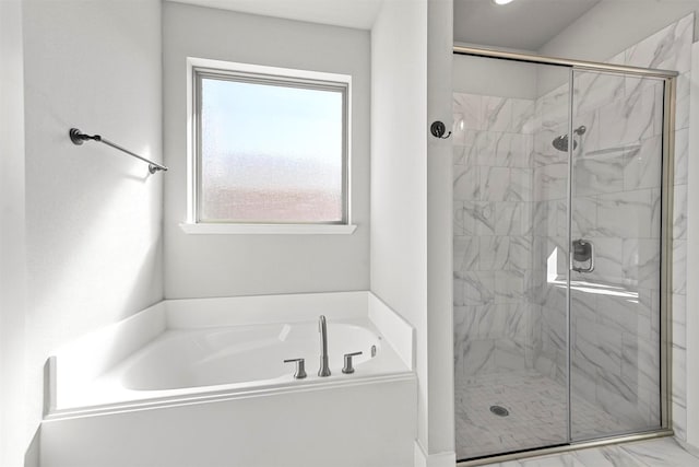 bathroom with a garden tub, a shower stall, and marble finish floor