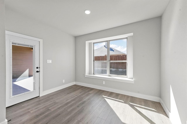 empty room featuring baseboards and wood finished floors