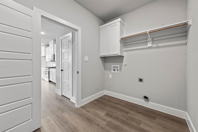 laundry room with baseboards, hookup for a gas dryer, dark wood-type flooring, washer hookup, and electric dryer hookup