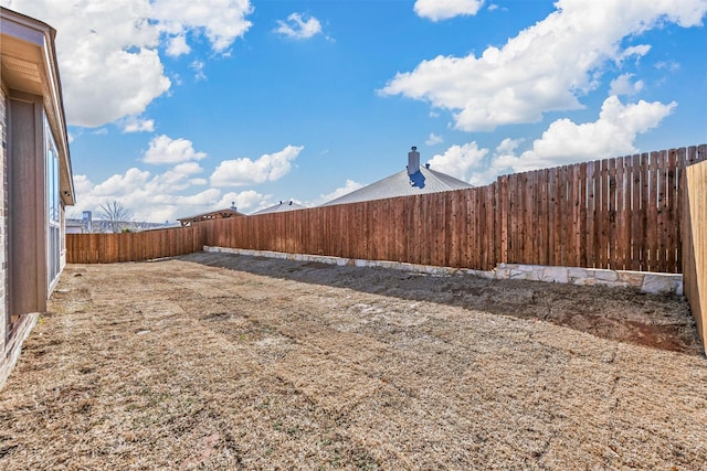 view of yard with a fenced backyard