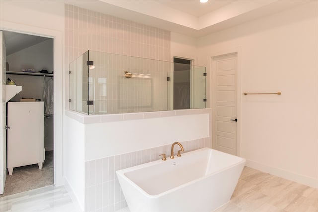 bathroom with separate shower and tub