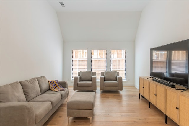 living room with high vaulted ceiling and wood-type flooring