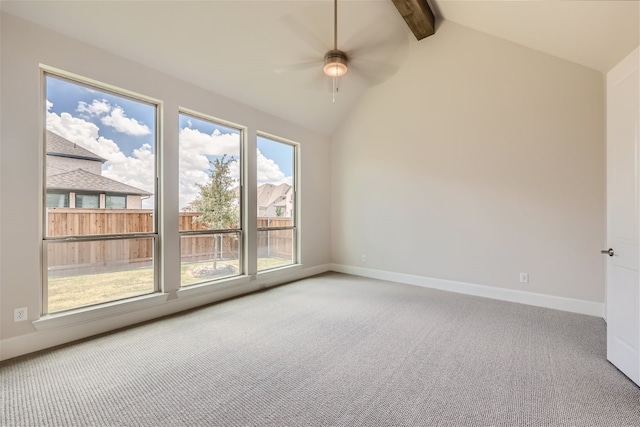 empty room with ceiling fan, lofted ceiling with beams, and carpet flooring