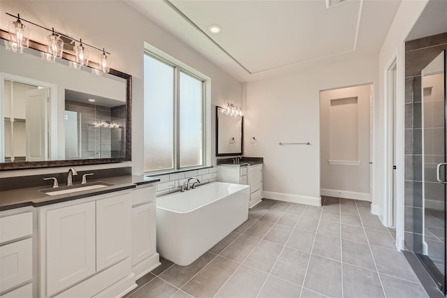 bathroom with plus walk in shower, tile patterned flooring, and vanity