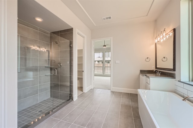 bathroom featuring shower with separate bathtub, vanity, and tile patterned flooring