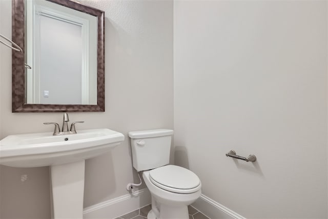 bathroom with tile patterned floors and toilet