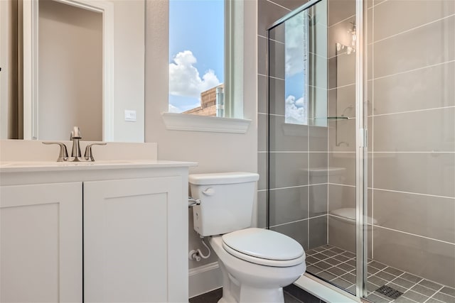 bathroom with toilet, vanity, and walk in shower