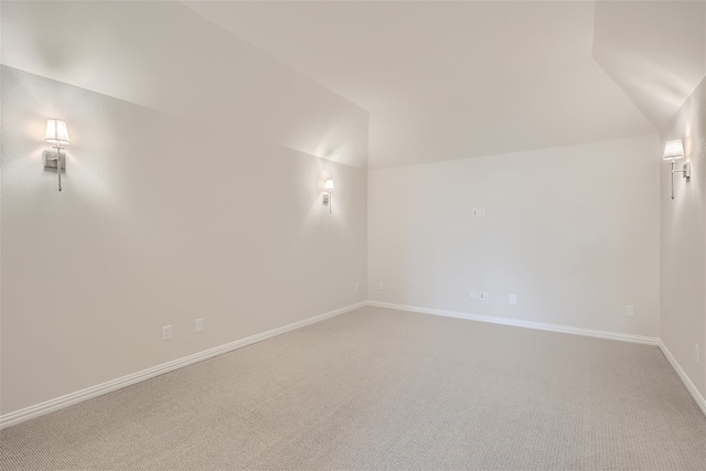 empty room with lofted ceiling and carpet floors