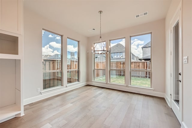 unfurnished sunroom featuring a notable chandelier