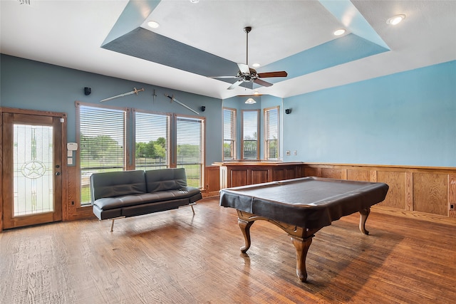 game room with ceiling fan, pool table, wood-type flooring, and a tray ceiling