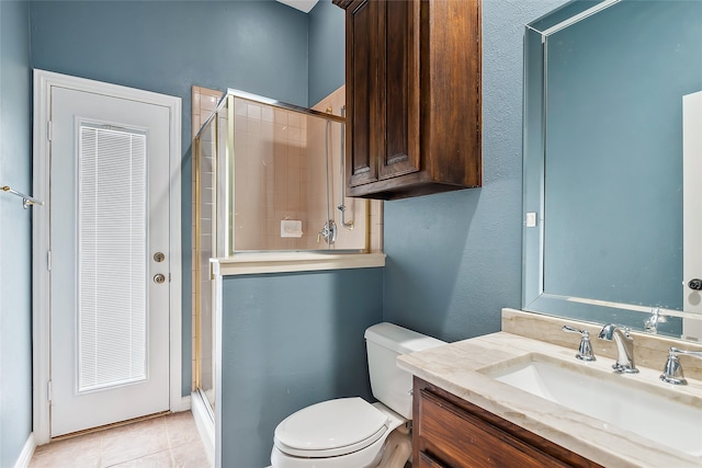 bathroom with vanity, an enclosed shower, tile patterned floors, and toilet