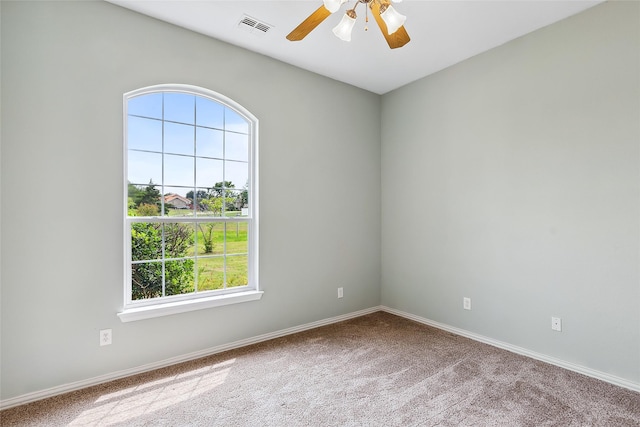 carpeted spare room featuring ceiling fan