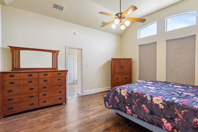 bedroom featuring wood-type flooring, high vaulted ceiling, and ceiling fan