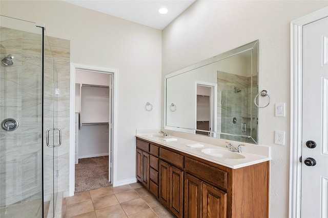 bathroom with vanity, a shower with door, and tile patterned flooring