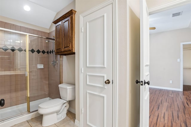 bathroom with an enclosed shower, wood-type flooring, and toilet