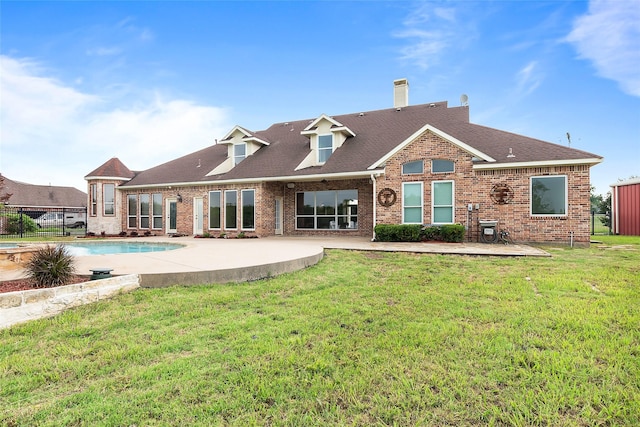 back of house with a patio area and a lawn