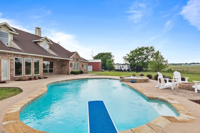 view of swimming pool featuring pool water feature, an outdoor structure, an in ground hot tub, a fire pit, and a patio