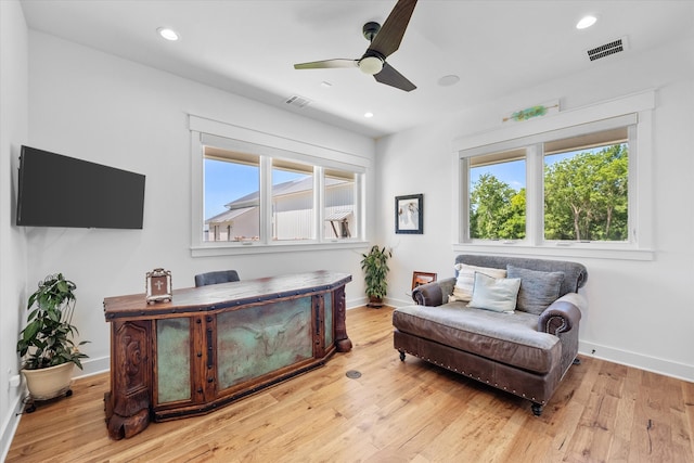 sitting room featuring a healthy amount of sunlight, ceiling fan, and light hardwood / wood-style flooring