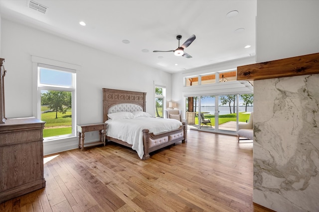 bedroom with wood-type flooring, ceiling fan, and access to exterior