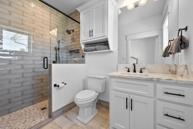 bathroom with walk in shower, oversized vanity, and toilet