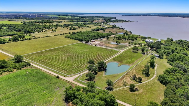 drone / aerial view featuring a rural view and a water view