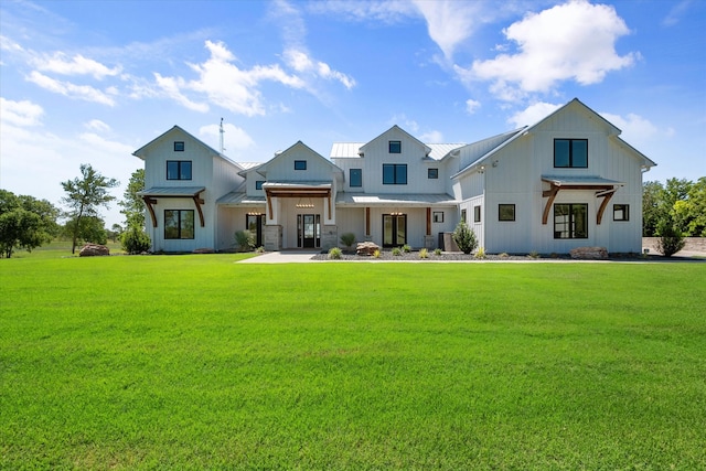 modern farmhouse style home featuring a front yard