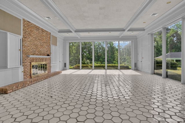 unfurnished sunroom featuring beam ceiling, a wealth of natural light, and coffered ceiling