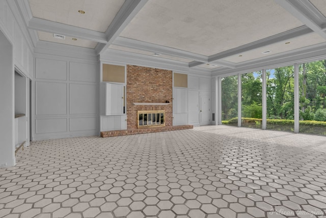 unfurnished living room featuring a fireplace, beamed ceiling, coffered ceiling, and ornamental molding