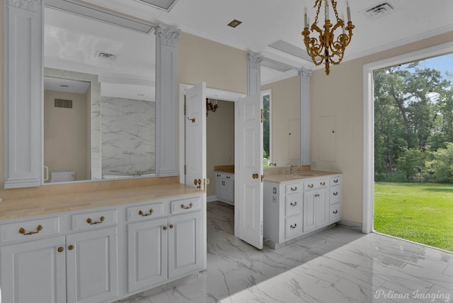 interior space featuring white cabinetry, sink, crown molding, and decorative light fixtures