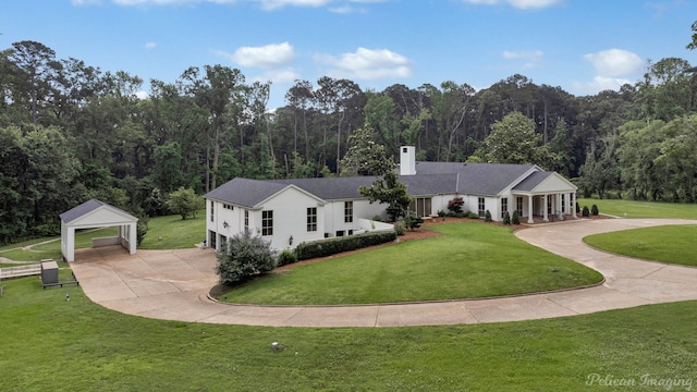 ranch-style home with an outbuilding, a garage, and a front lawn