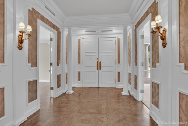 foyer with light parquet flooring and ornamental molding