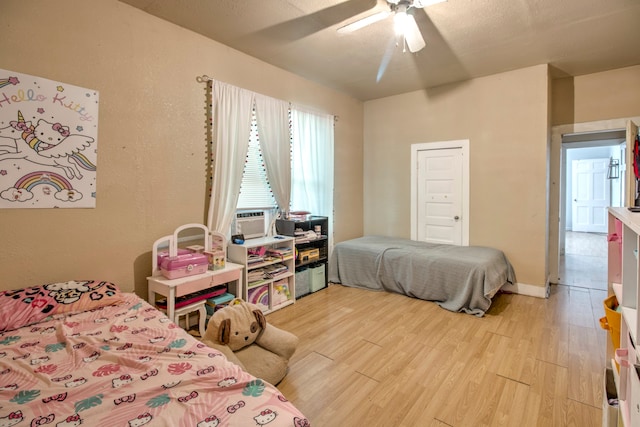 bedroom with ceiling fan and light hardwood / wood-style floors