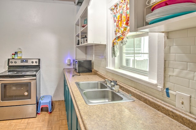 kitchen featuring sink, light parquet floors, blue cabinetry, and stainless steel appliances